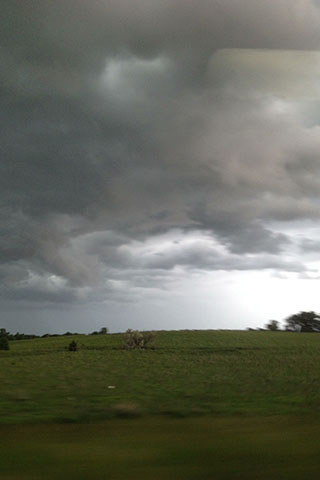 overcast skies over fields of green in Kansas