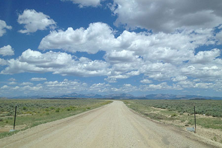 The Wind River Range in the distance from the dirt road