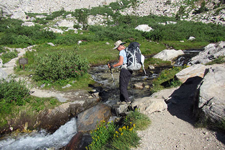 Crossing the creek to reach the Meadows camping zone